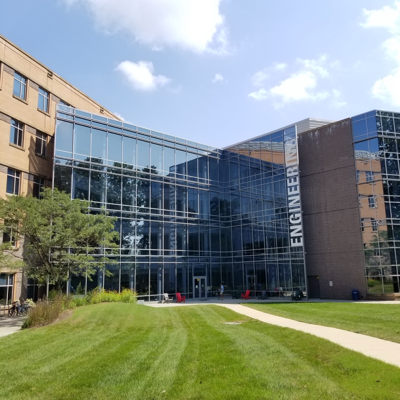 A large building with the words 'ENGINEERING' on the right, infront of a green lawn.